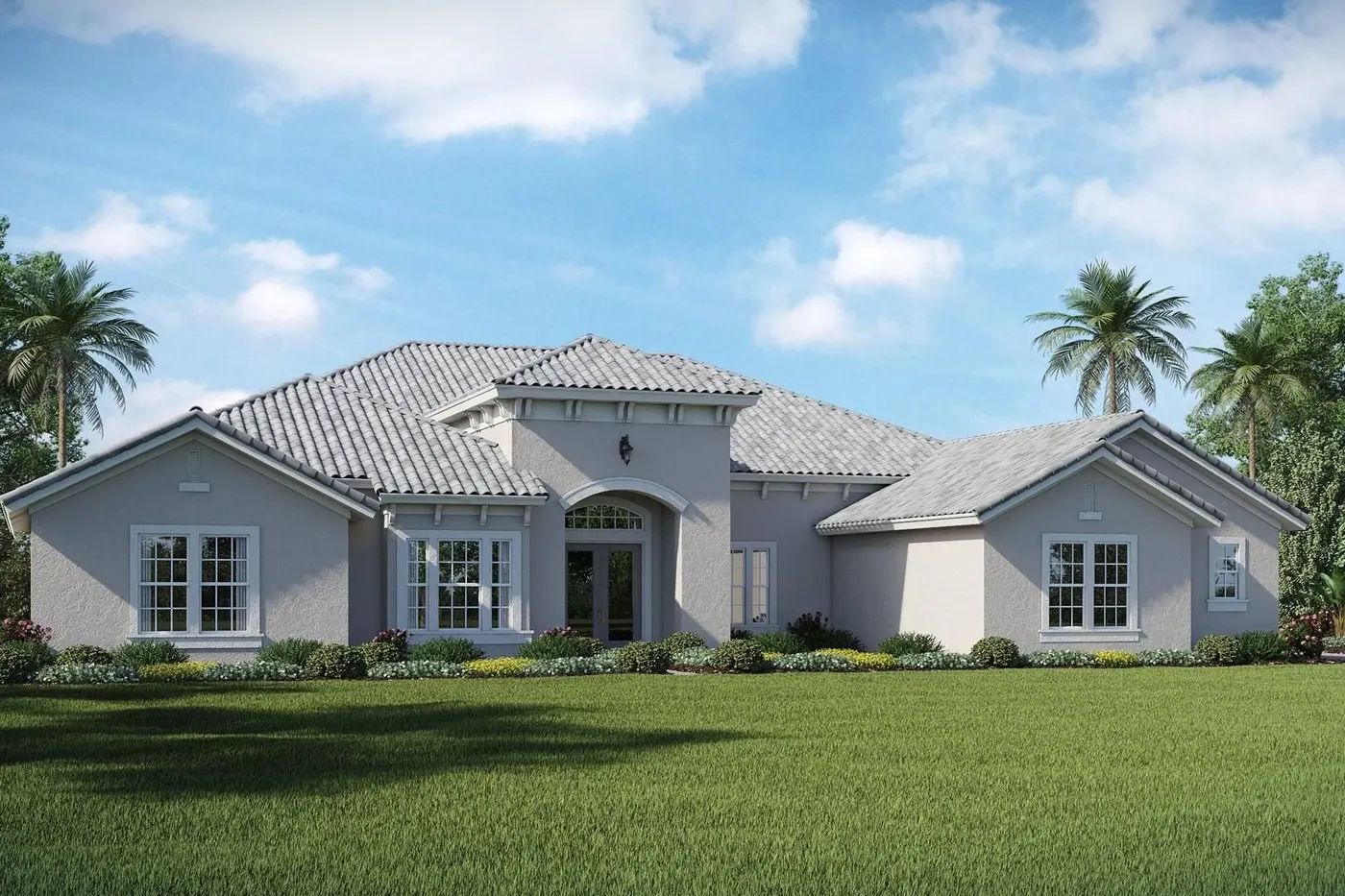 Large gray house with manicured lawn and palm trees under blue sky
